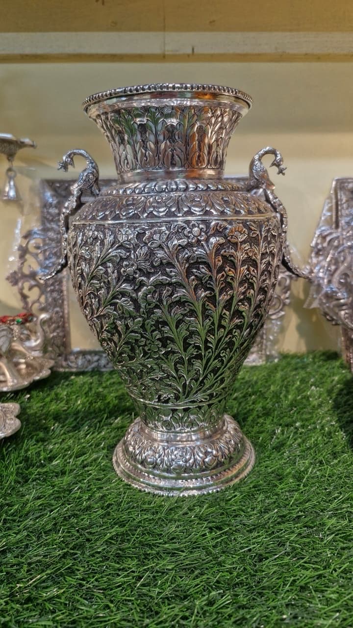 Hand-chased silver vase with peacock handles and floral repoussé work